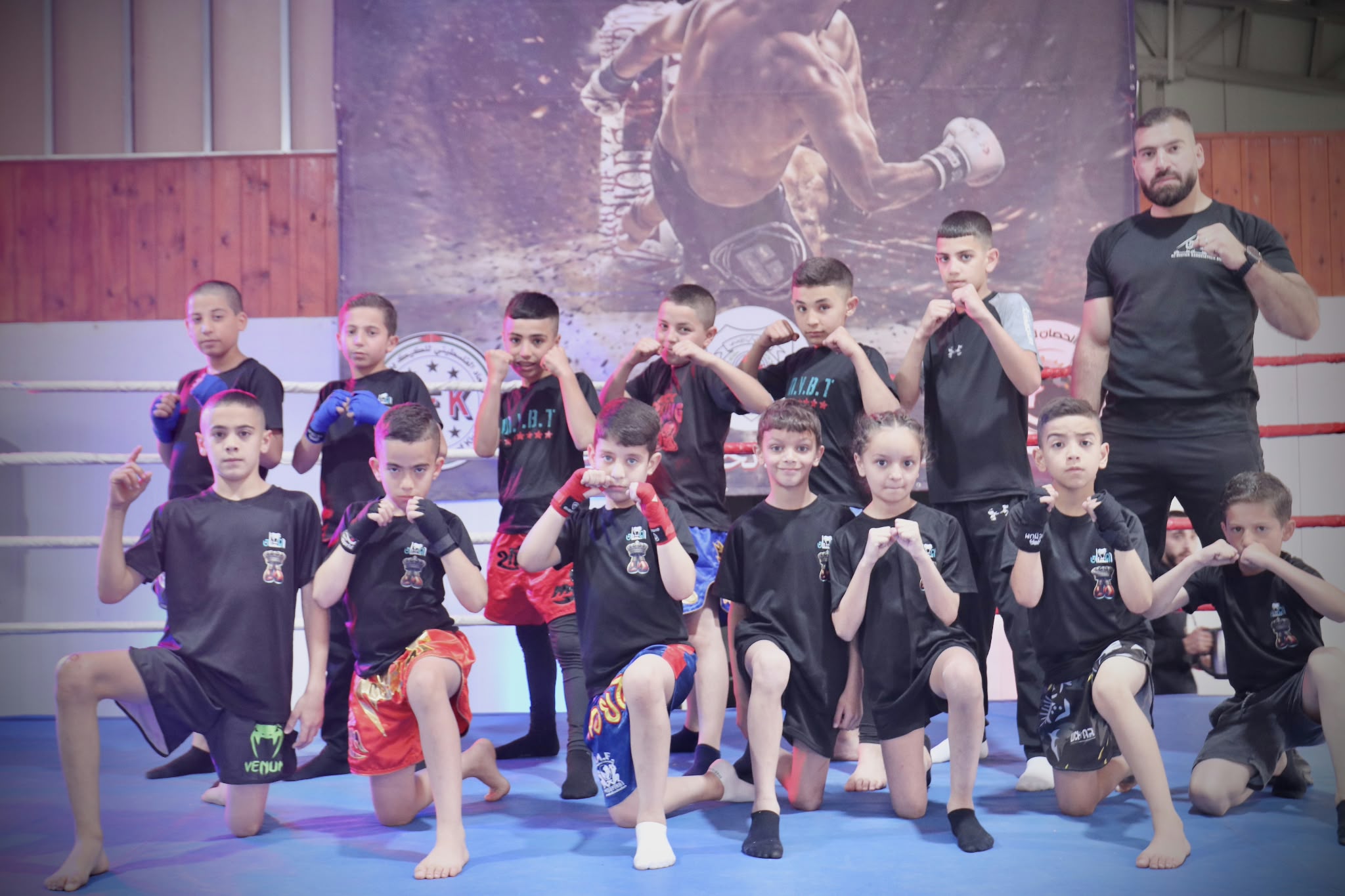 Young participants and their coach in a sports session